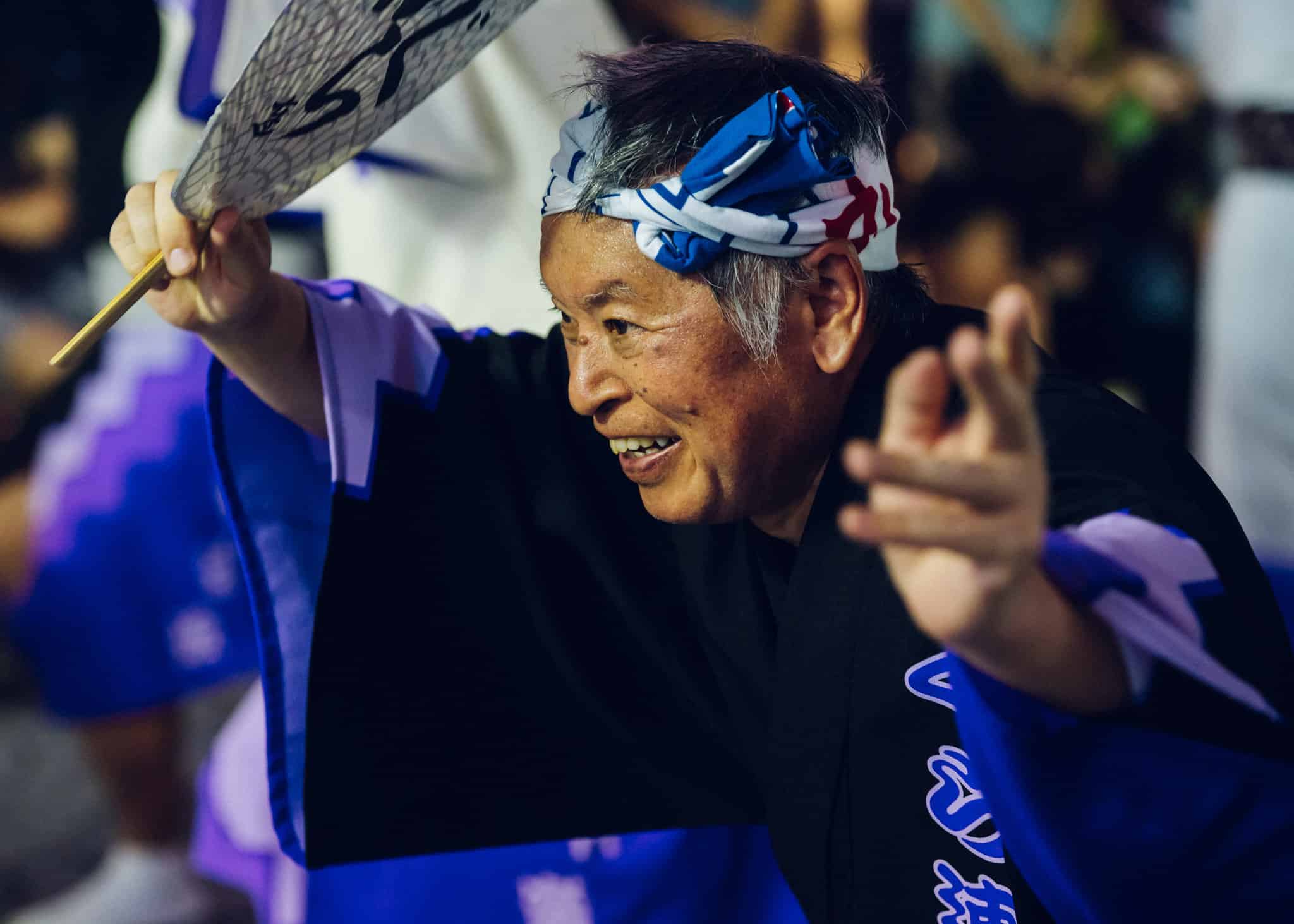 An Japanese man smiles as he participates in Awa Odori.
